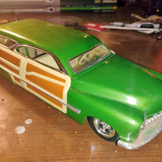 Green Mercury woodie diecast car with white stripe and chrome front bumper
