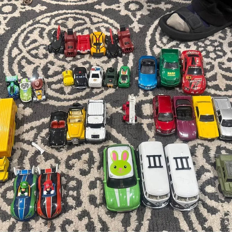 Assorted toy diecast cars and trucks, mixed colors and styles
