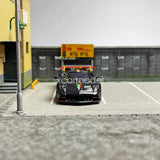 Black 1/64 diecast sports car model, front view with detailed grille and headlights