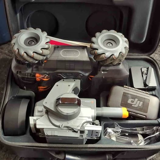 DJI RoboMaster robot with controller and parts in protective case