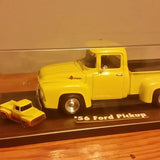 Yellow diecast Ford pickup model truck with V8 lettering and small companion car