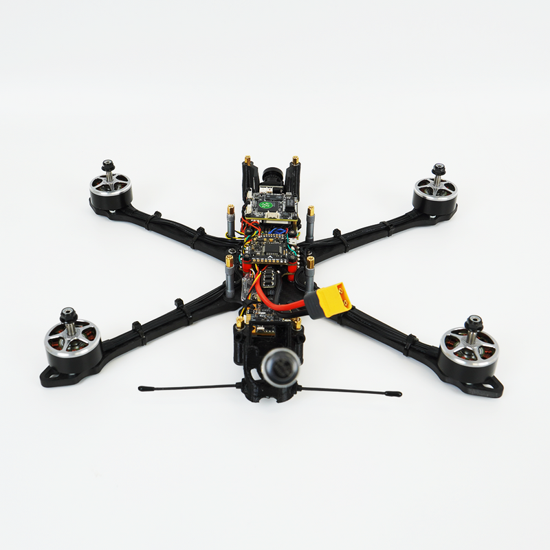 Racing drone with camera, black frame, four arms, propellers, visible wiring