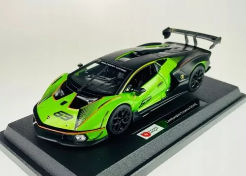 Green and black diecast model car with rear spoiler on display base, 1:24 scale