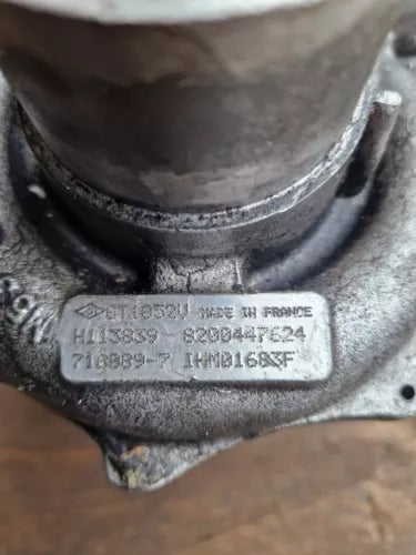 Metal diecast car part with embossed barcode and model text
