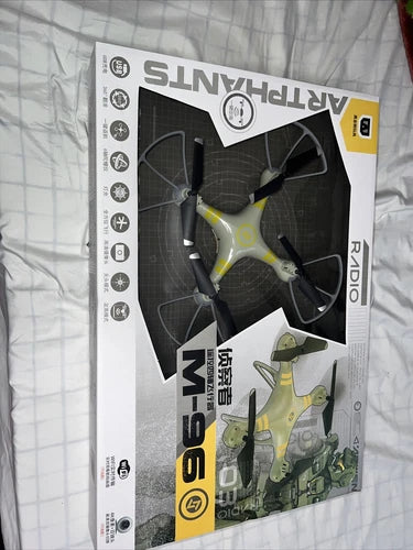 Boxed mini drone, yellow and black with visible propellers