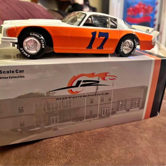 Orange diecast race car with blue 17 decal, silver wheels, in display box