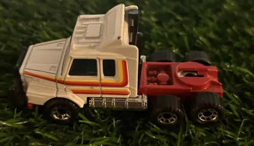 White diecast cab truck toy with orange stripe, front three-quarter view