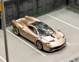 1:64 scale gold diecast sports car model with black roof and detailed front grille