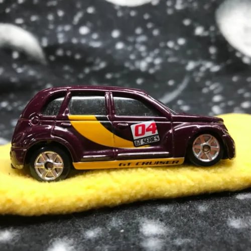 Die-cast model car, maroon with yellow stripe and 04 GT decals, 1/64 scale