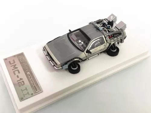 Gray diecast model car toy with open hood and detailed engine, angled view.