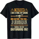 Black drone pilot T-shirt with caution graphic and bold text: I am flying my drone