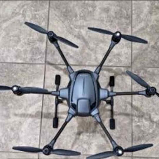 Compact foldable quadcopter drone with four propellers, front view