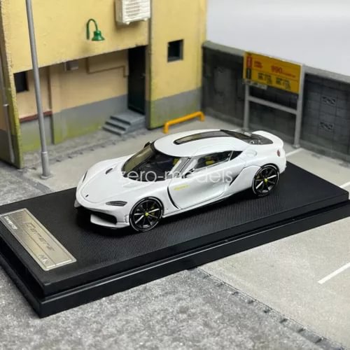 1/64 scale Koenigsegg Gemera white diecast toy car with black wheels on display base