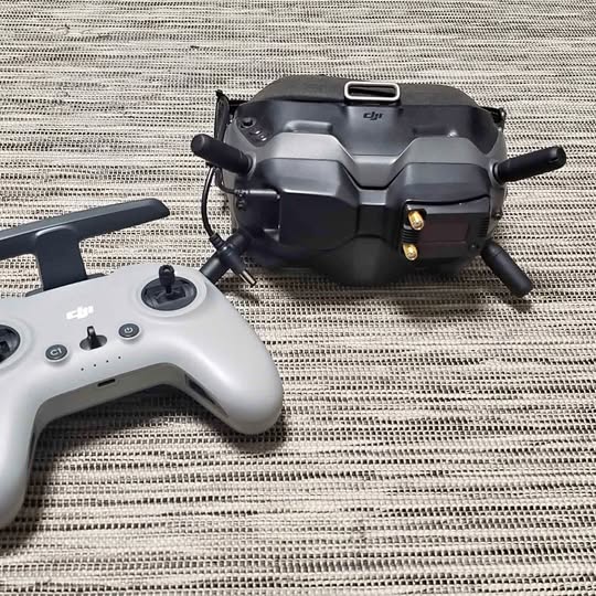 DJI goggles with analog module and DJI Remote 2 controller, both visible