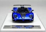 Blue racing diecast sports car model with black hood, front view and headlights