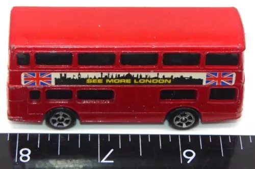 Red diecast London double-decker bus with black windows, UK flags, and detailed front