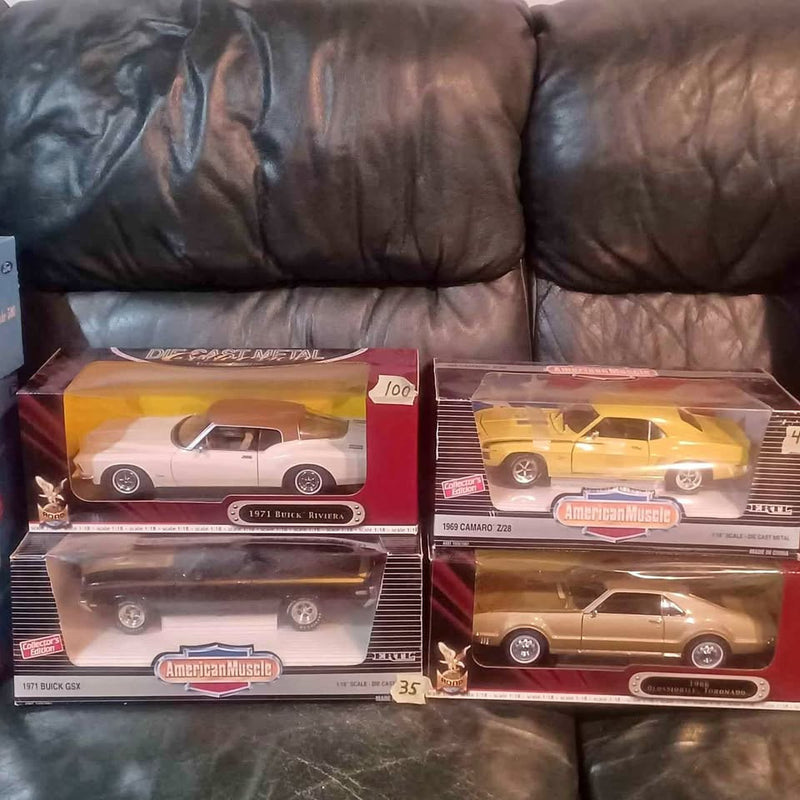 Boxed diecast car set with four vehicles in display boxes, white, yellow, brown cars