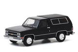 1/64 diecast model SUV, black 1989 Chevy Blazer style, white wheels