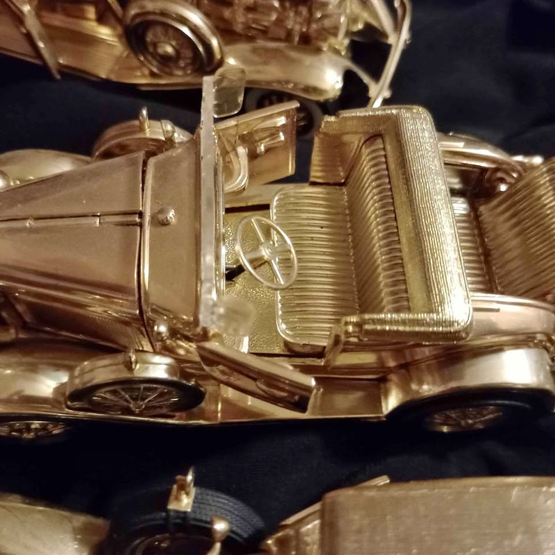 Gold diecast car model, close-up of engine and front grille detail