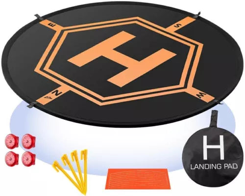 Round black RC drone landing pad with orange geometric logo and included pieces