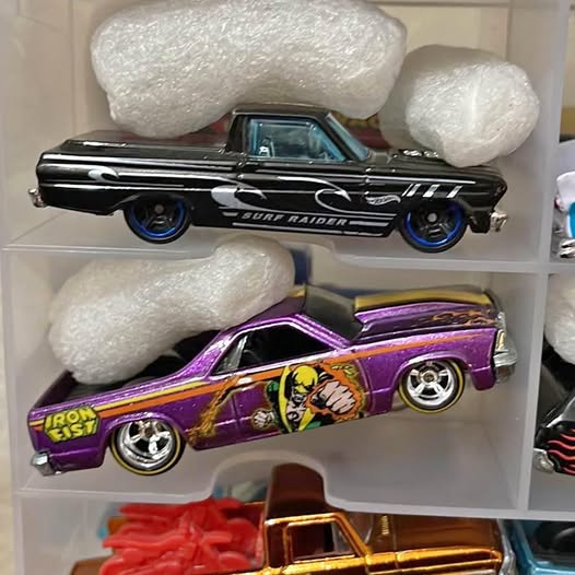 Black diecast pickup truck with blue wheel rims and Mission TX-style graphics.