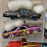 Black diecast pickup truck with blue wheel rims and Mission TX-style graphics.