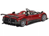 Red metallic diecast model car with open cockpit and black aero wing