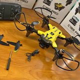 Yellow quadcopter drone with camera and four black propellers