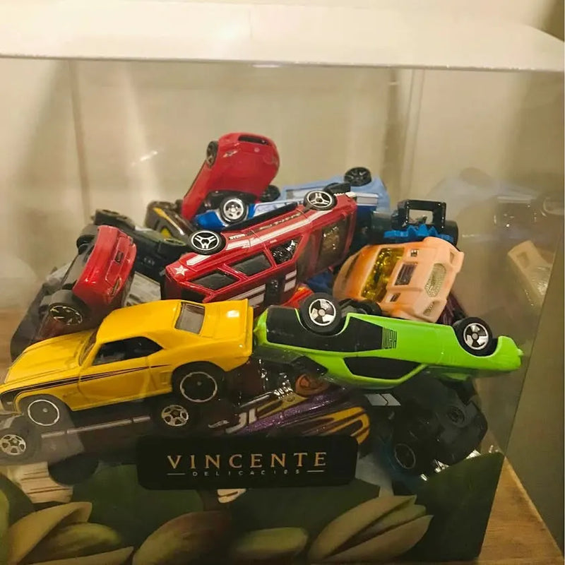 Diecast toy cars set with red, blue, yellow, green, and black vehicles in display case