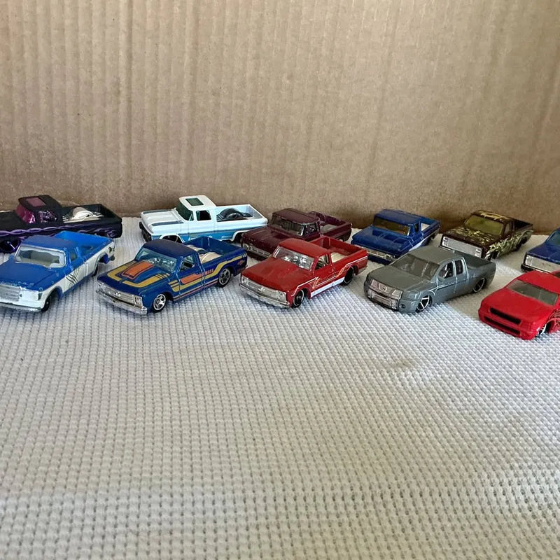 Diecast custom pickup trucks display, mixed colors, multiple models laid out
