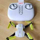 White quadcopter drone with camera mount and four green-prop propellers, top view