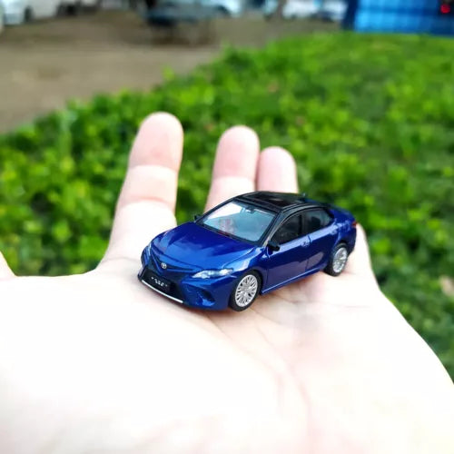 Blue diecast sports sedan model car with detailed front grille and headlights
