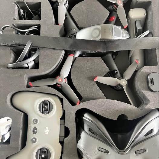 FPV drone and V2 goggles in open packaging, with controller and accessories