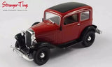 Red and black diecast model car, front three-quarter view with open grille and bumper