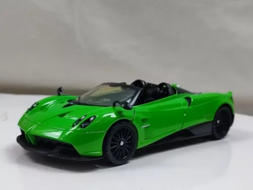 Green convertible diecast roadster toy car with black wheels and open cockpit