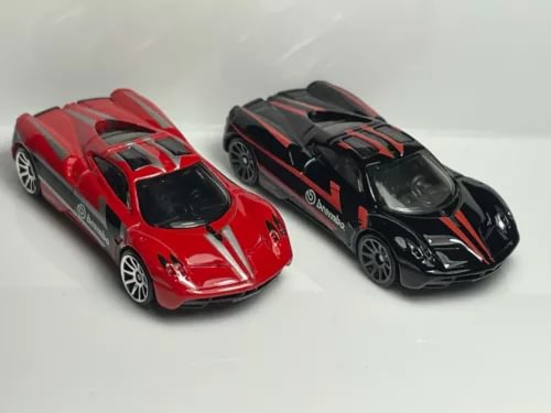 Set of two 1:64 scale diecast race cars, red and black with decals