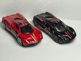 Set of two 1:64 scale diecast race cars, red and black with decals