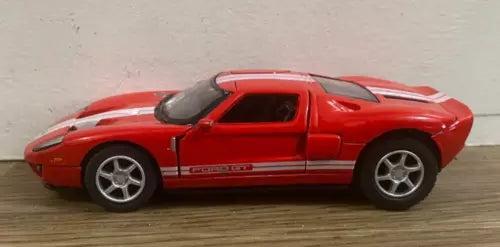 Kinsmart red 1:36 Ford GT diecast toy car with black racing stripe, cracked windshield