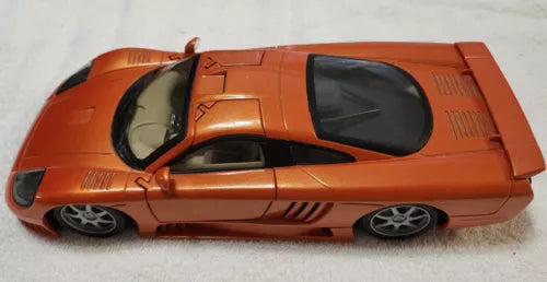 Orange 1:18 scale diecast sports car with black-tinted windows