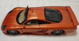 Orange 1:18 scale diecast sports car with black-tinted windows