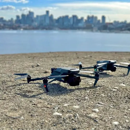 DJI drone with four propellers, black and gray, resting on ground