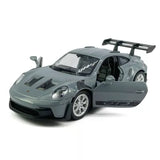 Gray 1:36 diecast model car with open door and rear wing, front 3/4 view