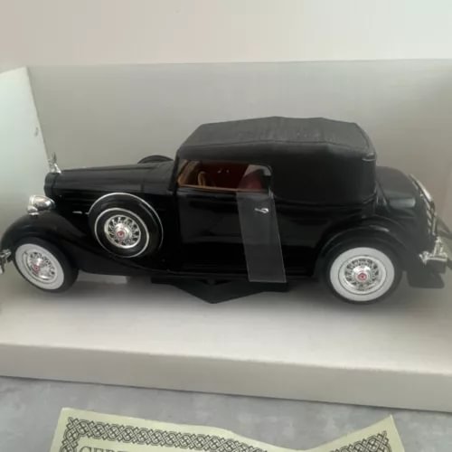 Black 1934 Packard diecast car model in display box, detailed chrome wheels