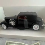 Black 1934 Packard diecast car model in display box, detailed chrome wheels