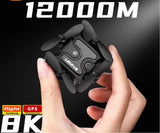 Black mini quadcopter drone with four propellers, held in hands.