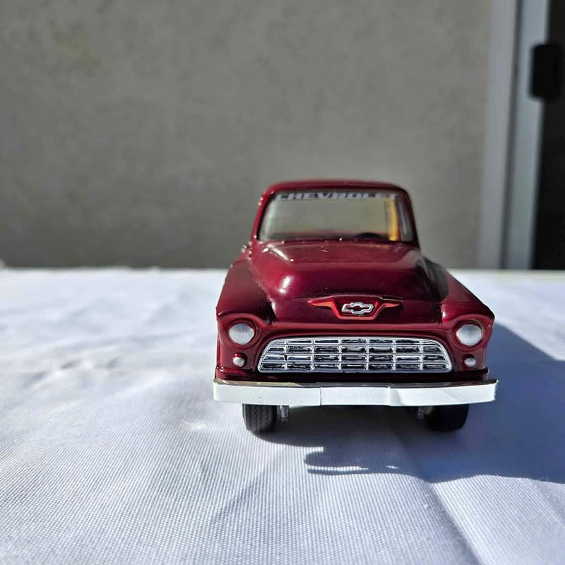 Red 1955 Chevrolet diecast car front grille, bumper, and headlights