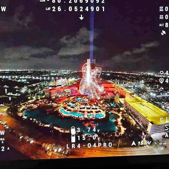 Drone aerial city view with tall tower and streets