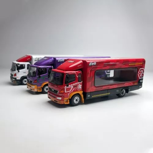 Red diecast transport truck model with cab and trailer, plus two smaller trucks