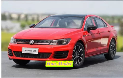 Red diecast model car with detailed front grille and VW logo, 1:18 scale
