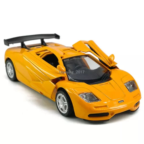 Orange diecast model race car with black cockpit detail, front-left view